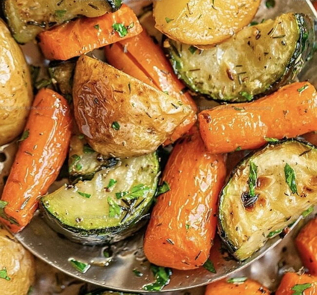 Why Garlic Herb Roasted Potatoes, Carrots, And Zucchini Hit The Spot